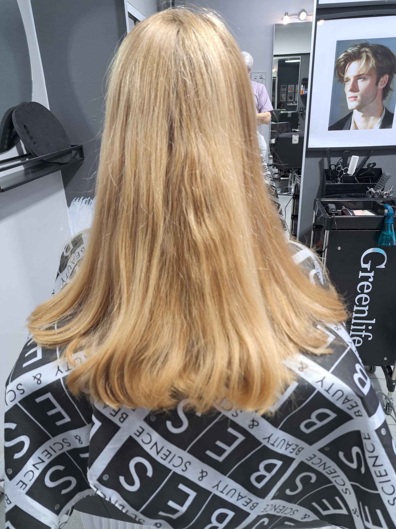 Long blonde hair styled with smooth layers by Konstantin Stylist