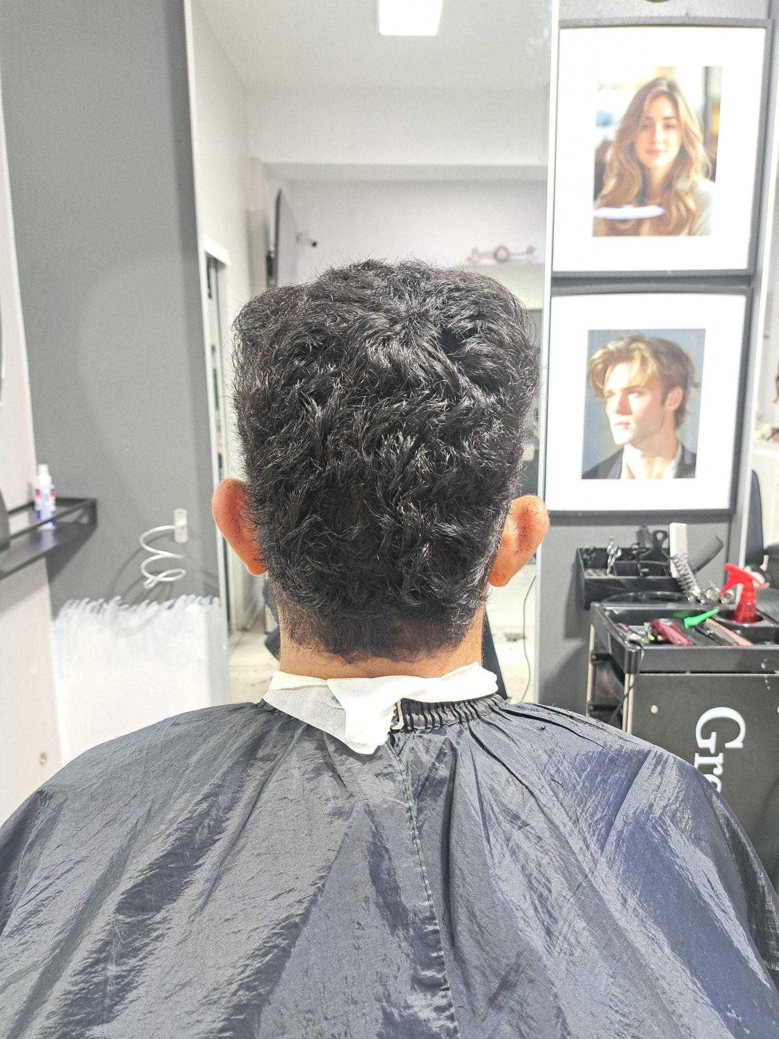 Curly men's haircut shaped at the neckline by Konstantin Stylist