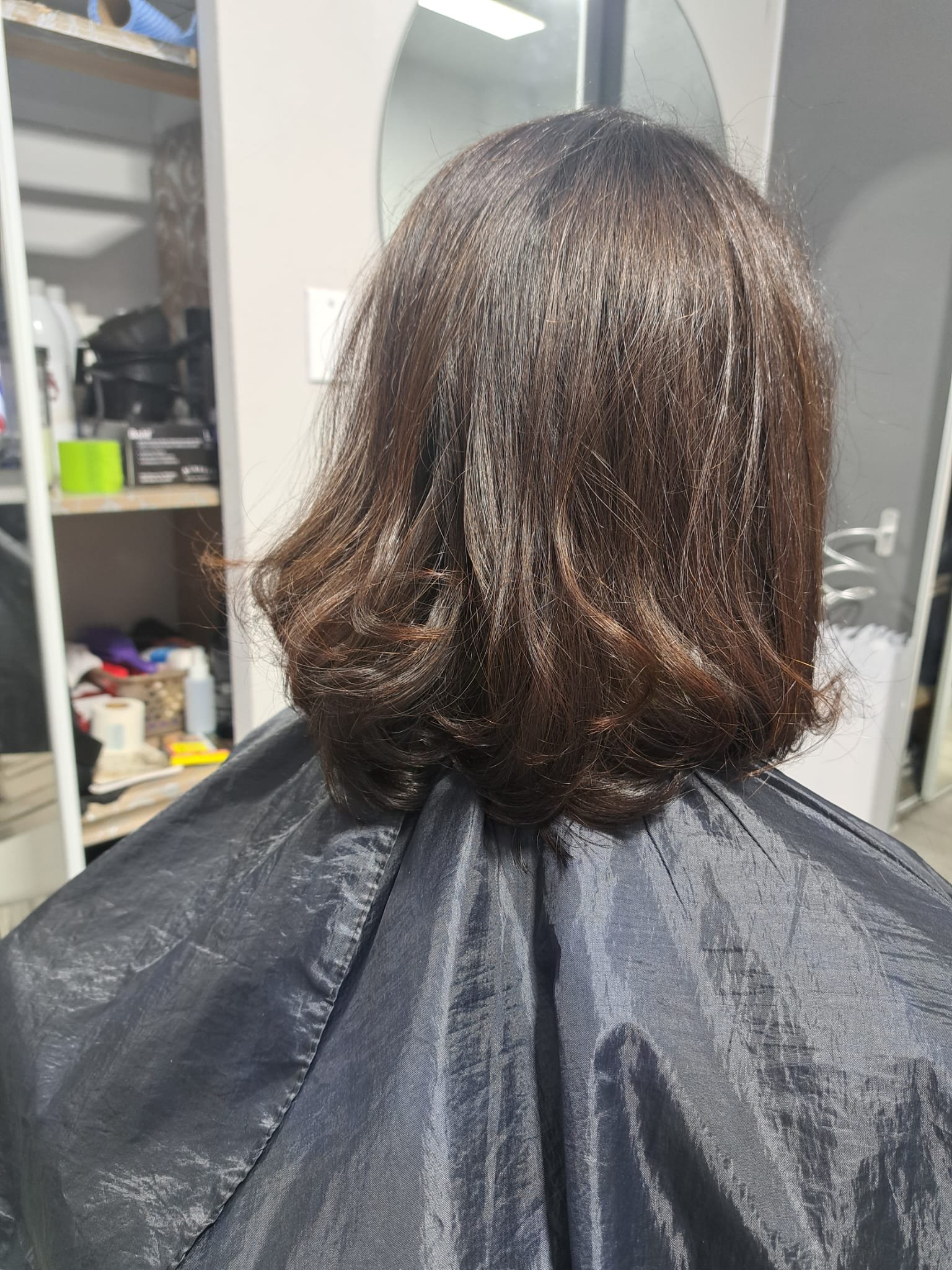 Glossy brunette shoulder-length haircut with curled ends by Konstantin Stylist